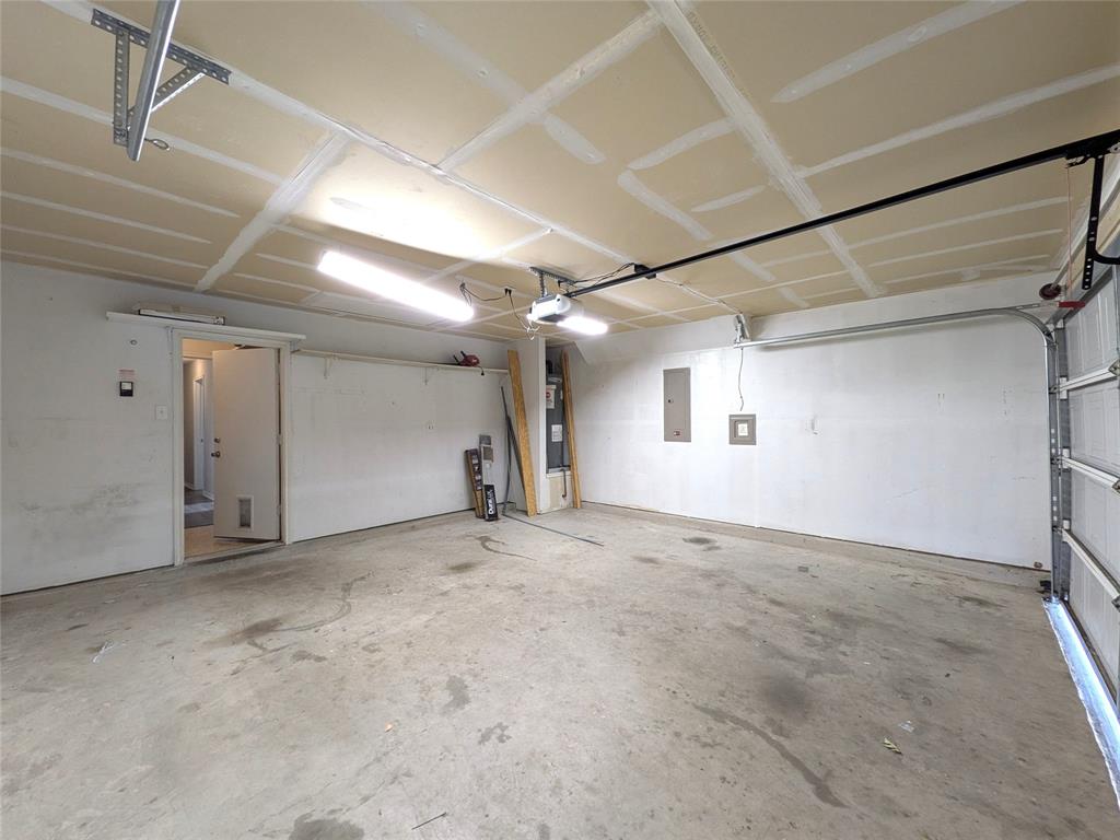 1736 Carolina Ridge Way Fort Worth, TX 76247 - Photo 28 of 33 Spacious garage with concrete flooring, overhead lighting, and an automatic garage door opener