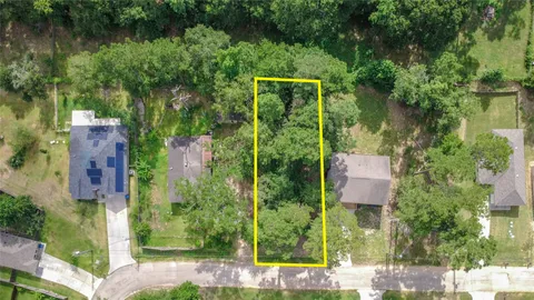 an aerial view of a house with a yard basket ball court and outdoor seating
