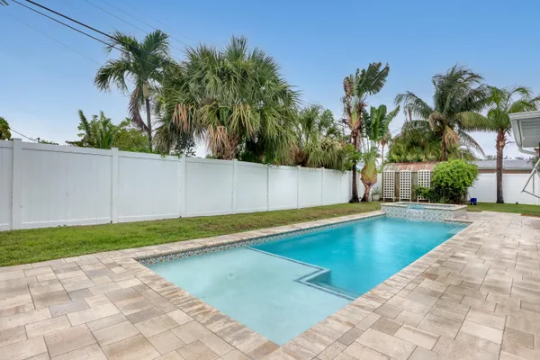 a view of a house with pool and sitting area