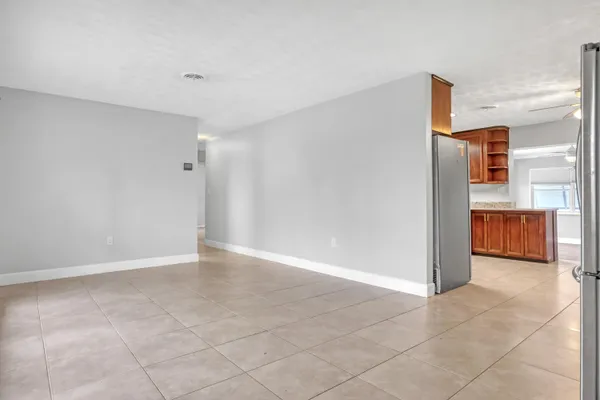 a view of a kitchen with a refrigerator and a sink