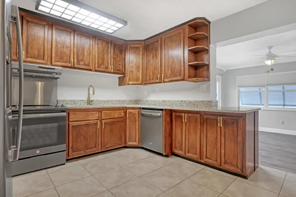a kitchen with stainless steel appliances granite countertop a sink and cabinets