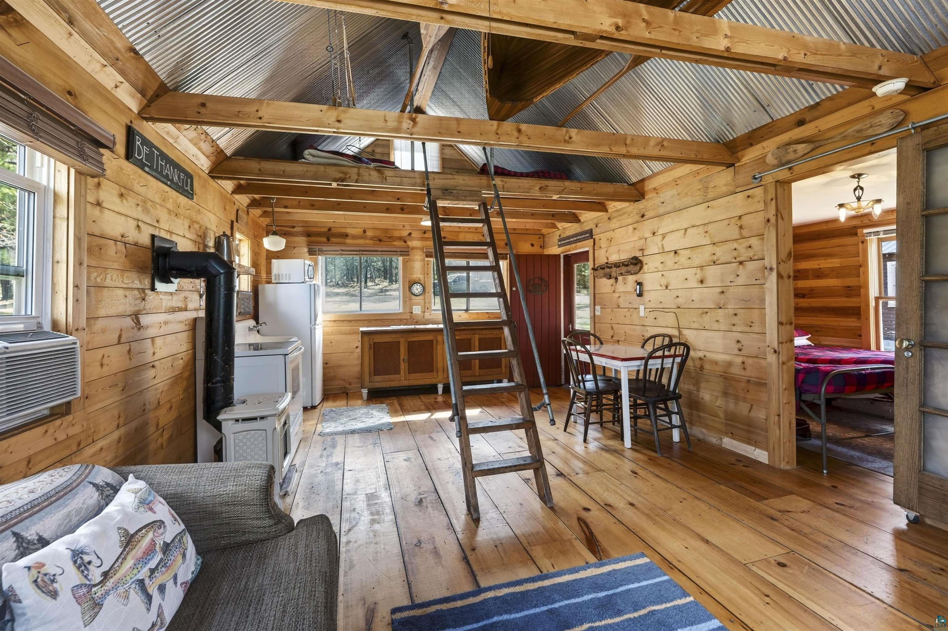 13885 Park Road Brule, WI 54820 - Photo 29 of 41 Rustic wood plank walls and flooring create a cohesive interior