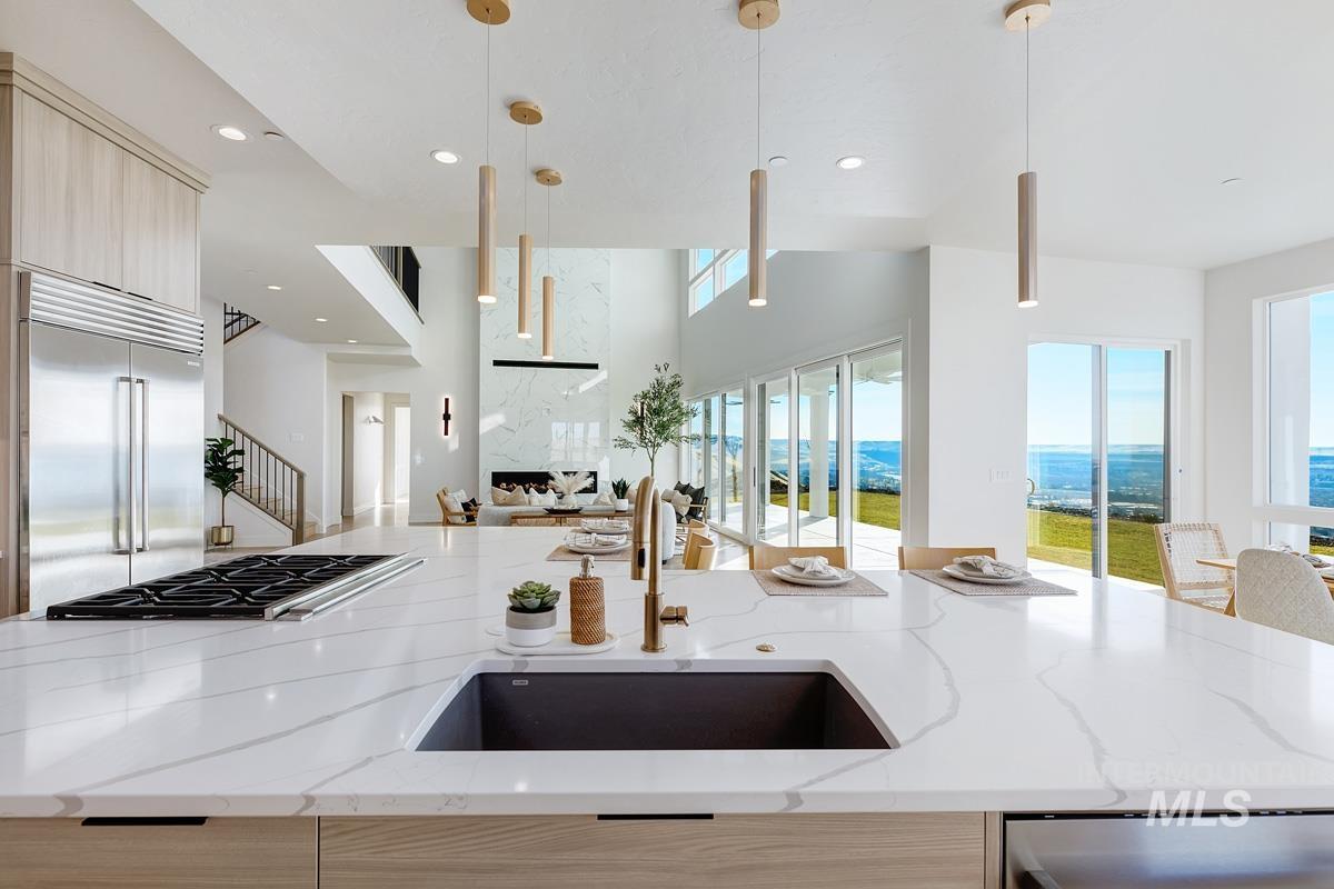 5825 East Prominence Court Boise, ID 83716 - Photo 16 of 45 Kitchen featuring light brown cabinetry, light stone countertops, modern cabinets, and recessed lighting
