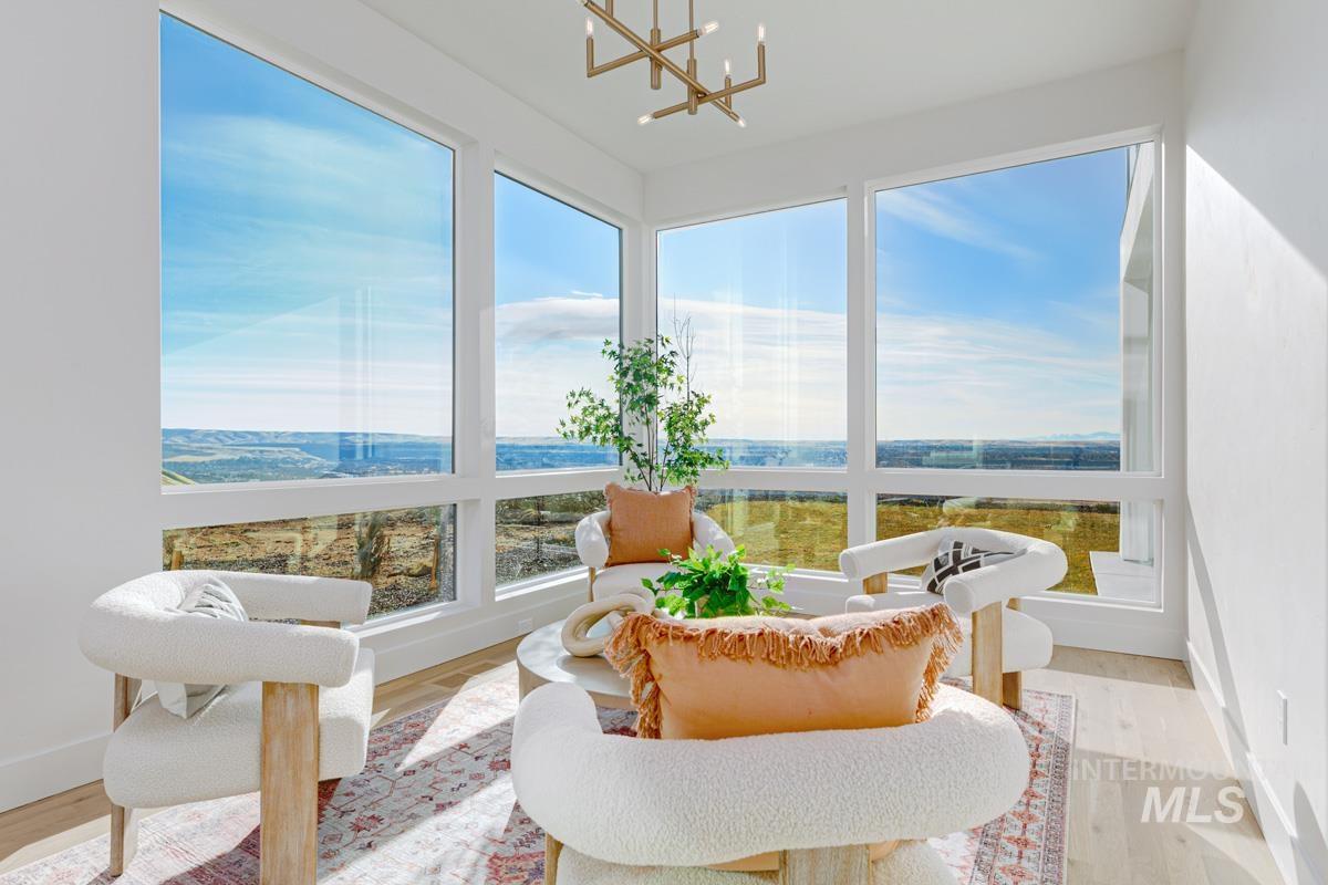5825 East Prominence Court Boise, ID 83716 - Photo 19 of 45 Sunroom / solarium featuring wood finished floors and a chandelier