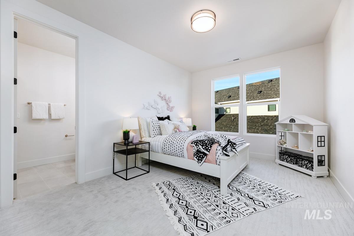 5825 East Prominence Court Boise, ID 83716 - Photo 33 of 45 Bedroom featuring light carpet and connected bathroom