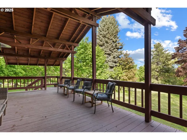 a view of a porch with furniture and wooden floor