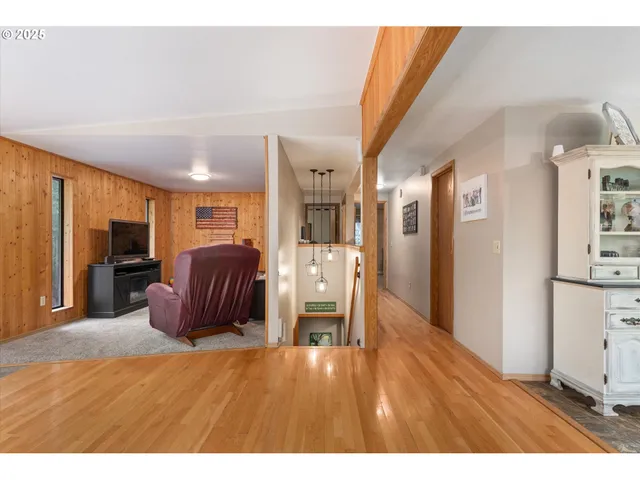 a living room with furniture and a kitchen view