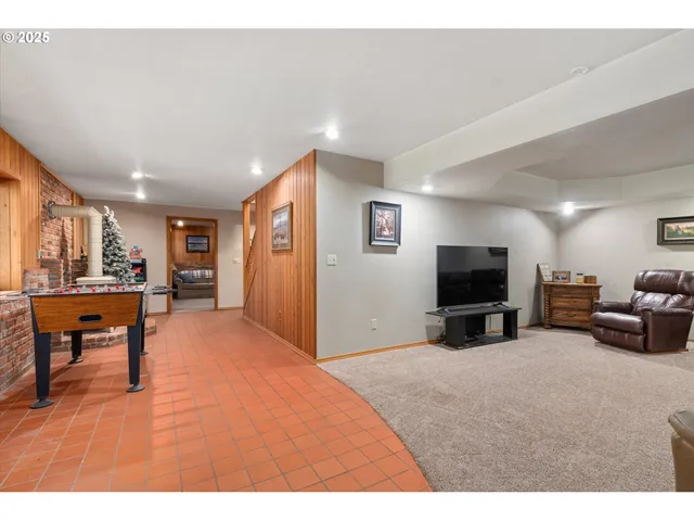 a view of a livingroom with furniture and a flat screen tv