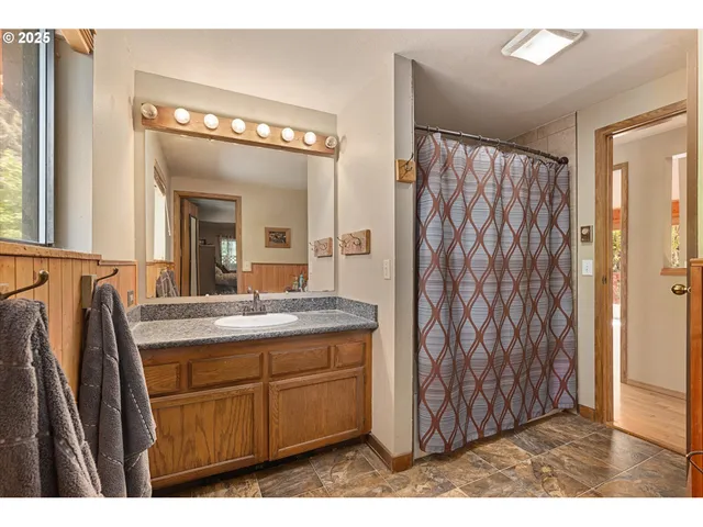 a bathroom with a sink a mirror and a shower