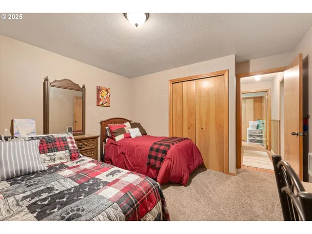 a bedroom with two beds and painted walls