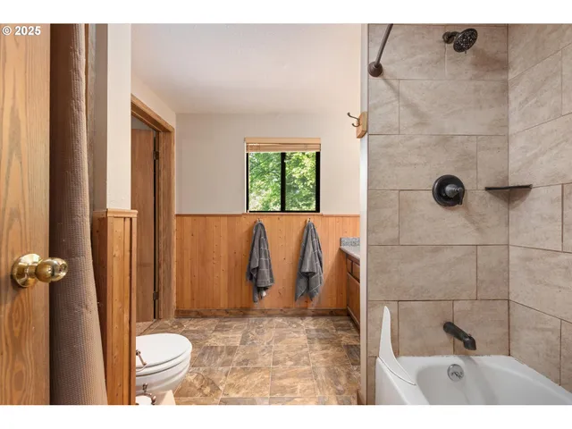 a bathroom with a toilet and shower
