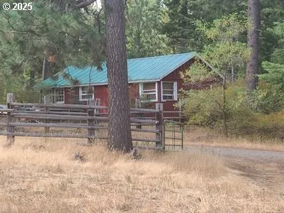 a front view of house with a garden