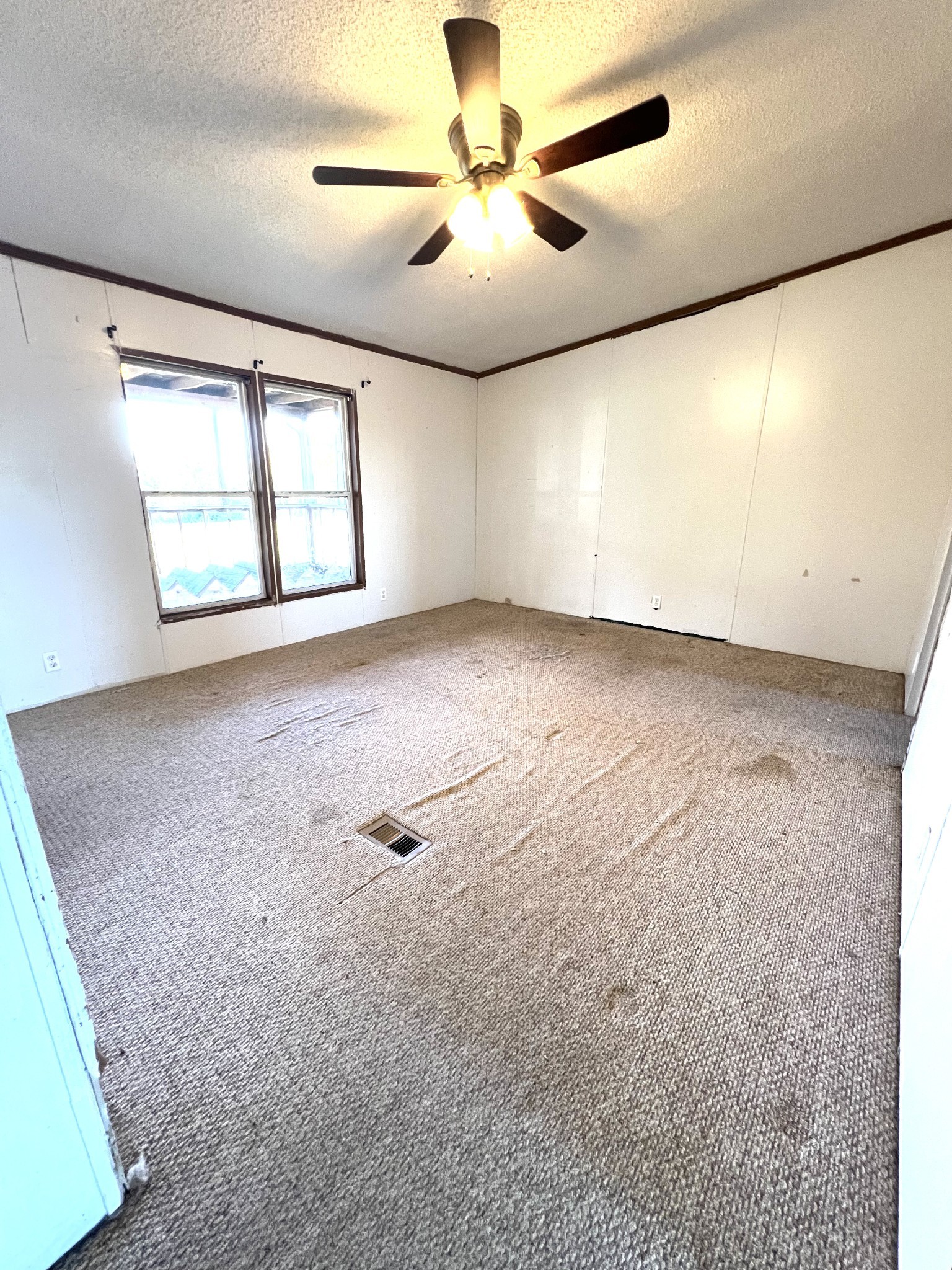 416 Walker Ridge Road Big Rock, TN 37023 - Photo 13 of 25 en empty room with windows and ceiling fan