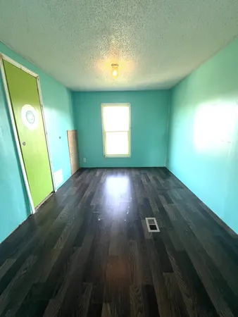 a view of room with window and hardwood floor