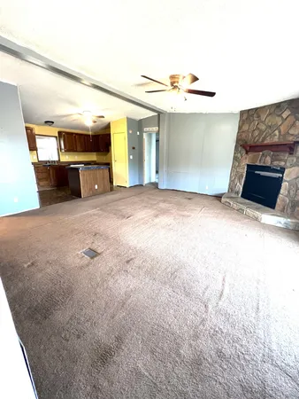 a view of an empty room with a fireplace