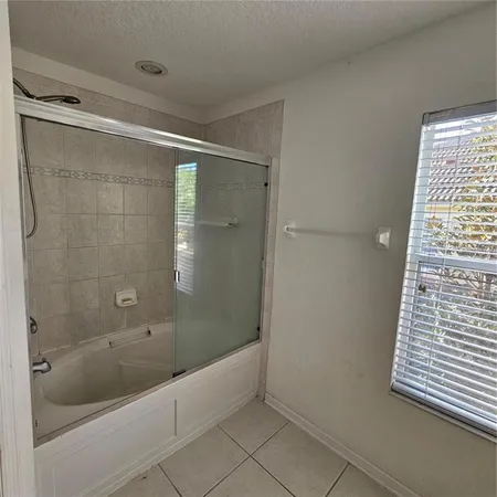 a bathroom with a bathtub and shower