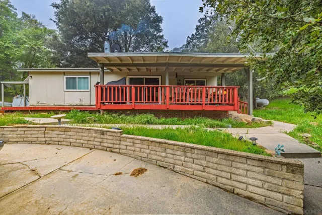 front view of a house with a bench in a yard