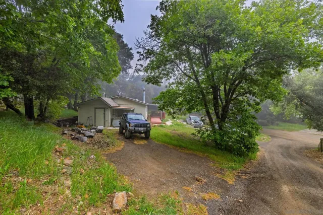 a view of a house with backyard and sitting area