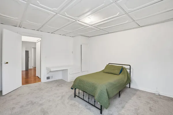 a bedroom with a bed and a mirror