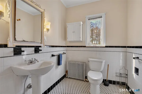 a bathroom with a sink toilet a mirror and shower