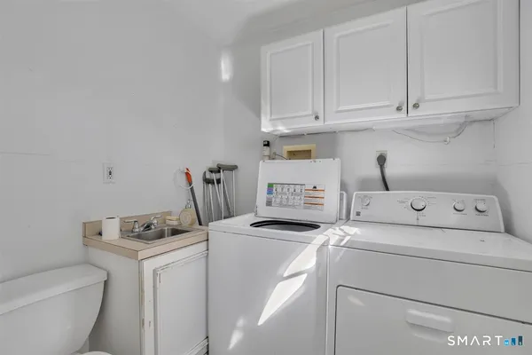 a view of storage and utility room with washer and dryer