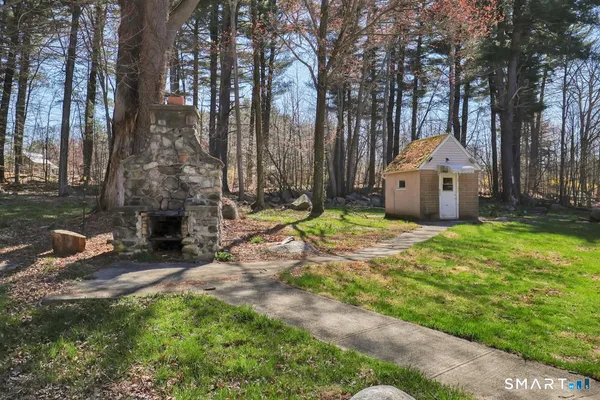 a backyard of a house with table and chairs
