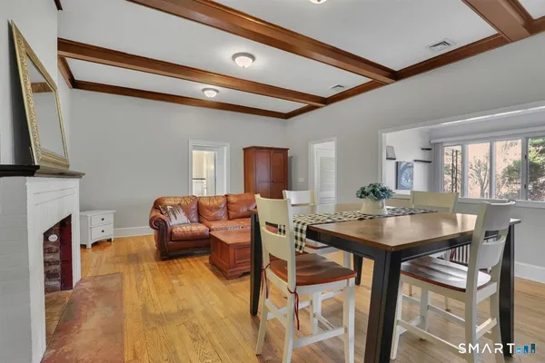 a view of a dining room with furniture and a flat screen tv