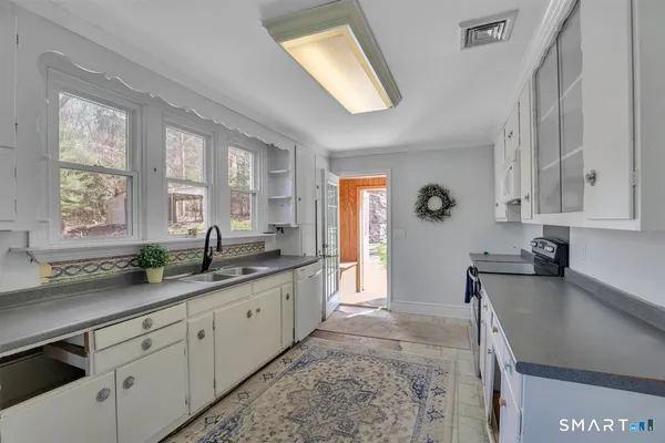 a large bathroom with a granite countertop sink mirror and a bathtub