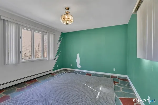 a room with a window and ceiling fan