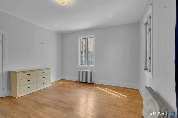 a view of a bedroom with cabinet and a bed