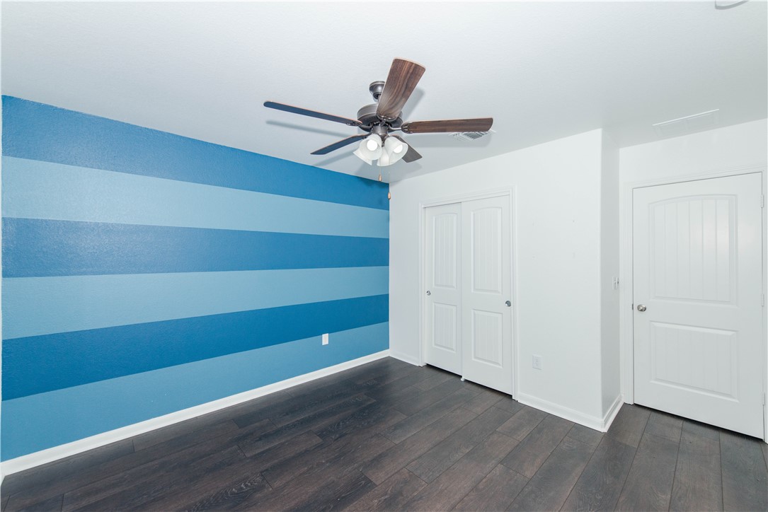 1007 Plateau Trail Georgetown, TX 78626 - Photo 24 of 32 a view of room with a ceiling fan and wooden floor