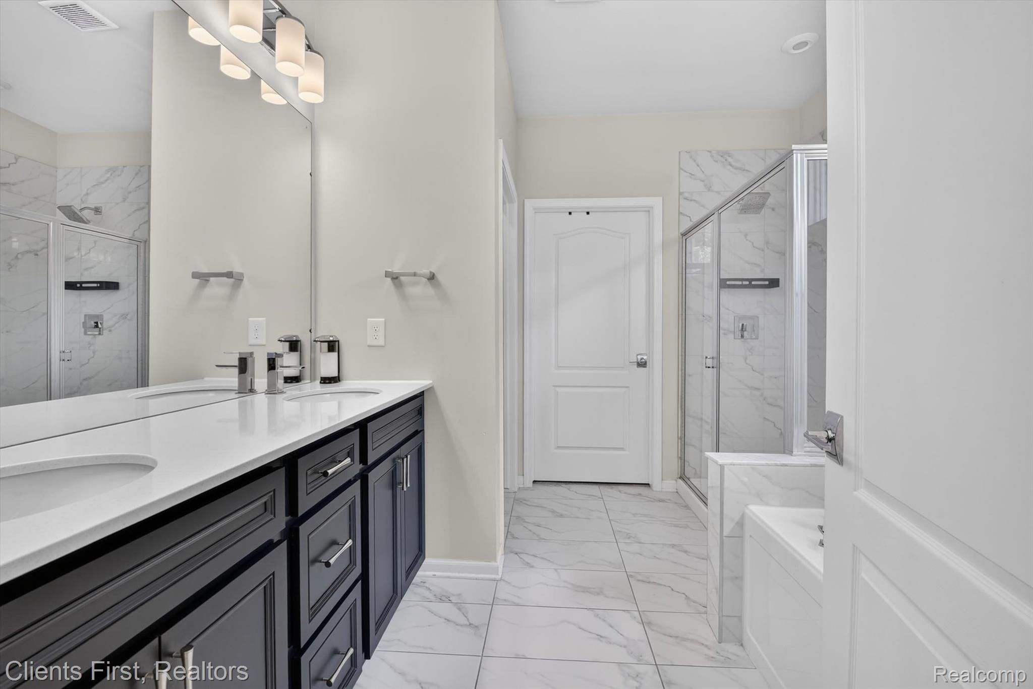 4699 Bingham Road Canton, MI 48188 - Photo 18 of 47 Bathroom featuring a dual vanity with dark wood cabinetry, white countertops, and undermount sinks