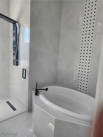 a bathroom with bathtub and shower
