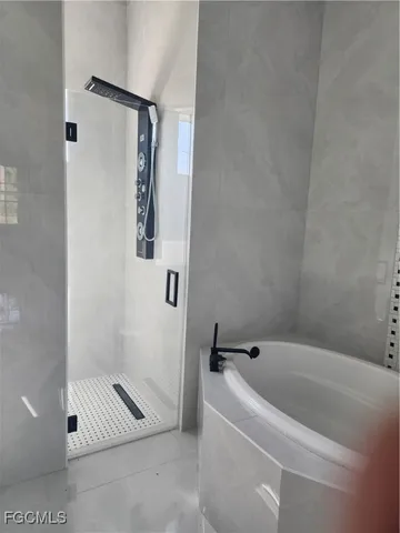a bathroom with a tub and a shower