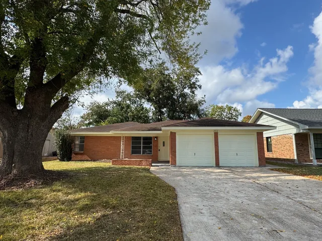 a view of a house with backyard space and a yard