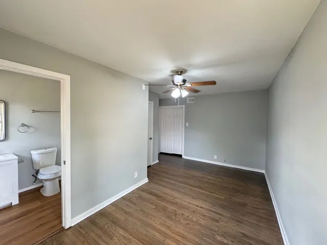 a view of an empty room and wooden floor