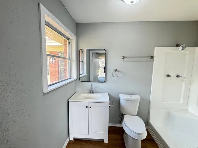 a white toilet sitting next to a bathroom sink
