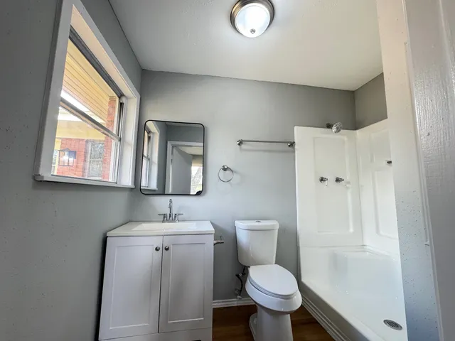 a bathroom with a toilet sink and mirror