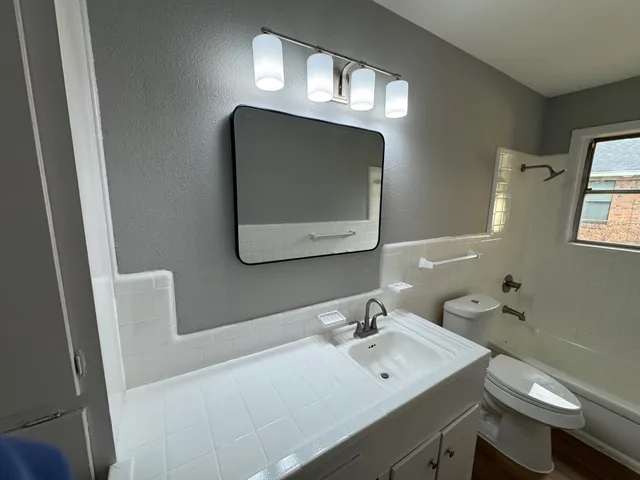 a bathroom with a sink vanity and mirror