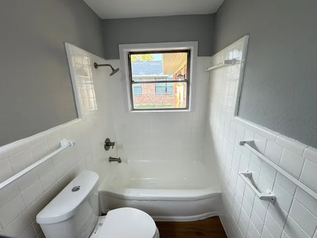 a bathroom with a toilet and a shower