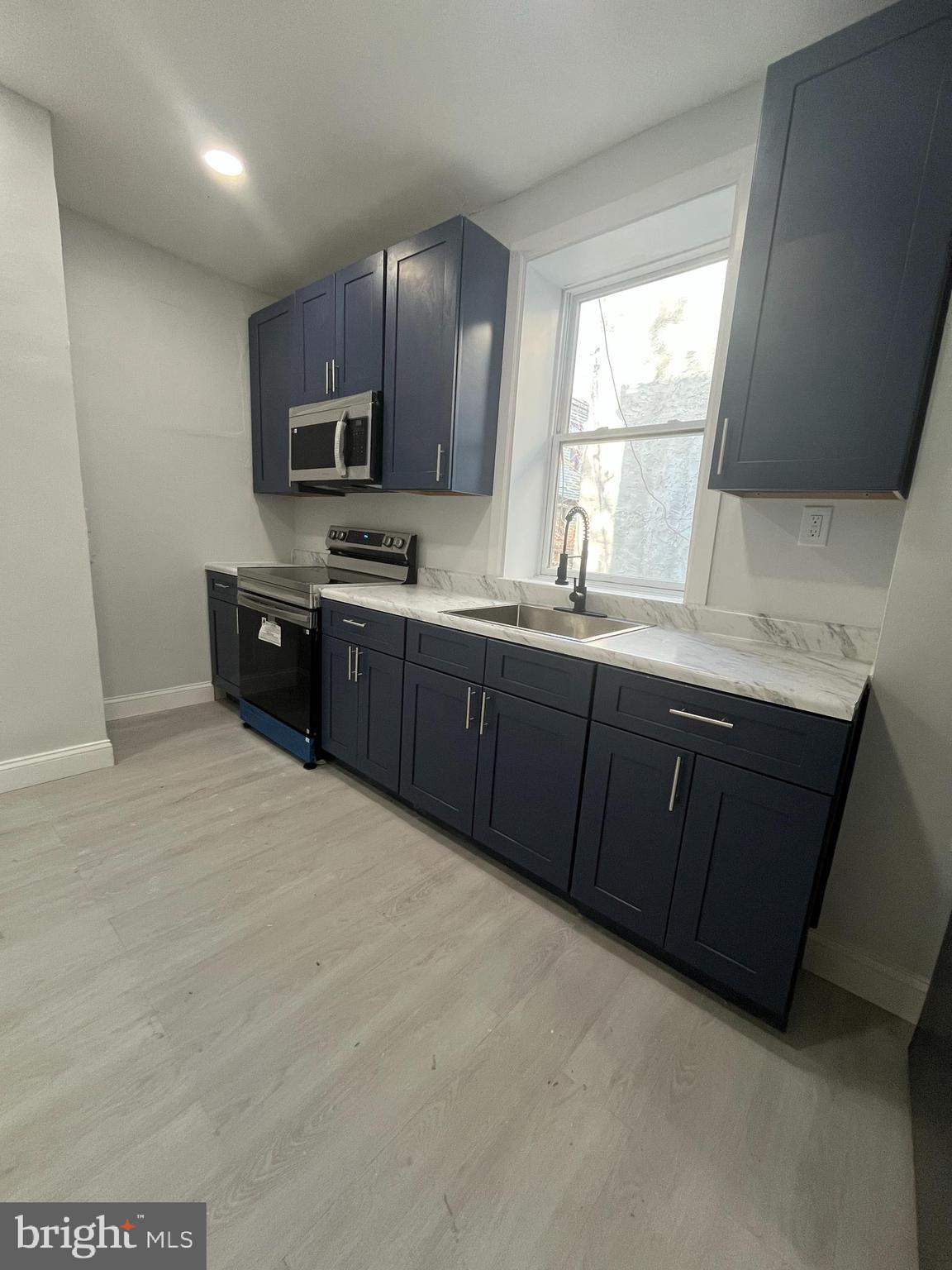2720 North Hemberger Street Philadelphia, PA 19132 - Photo 3 of 21 a large kitchen with stainless steel appliances granite countertop a sink dishwasher stove and wooden cabinets