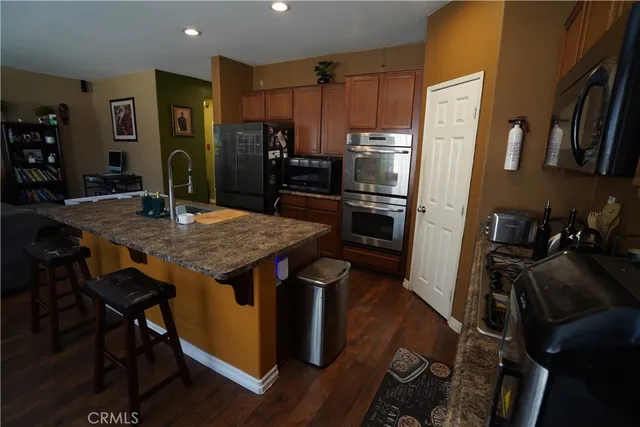 a kitchen with a table chairs refrigerator and stove