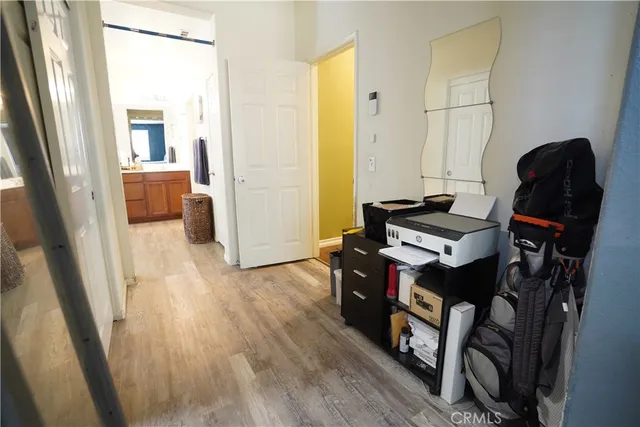 a living room with furniture and a mirror next to a window