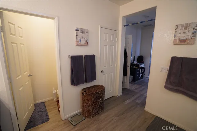 a view of a hallway with workspace and a couch