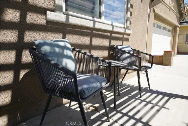 a view of a chairs and table in the balcony