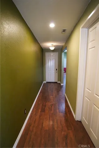 a view of gallery with wooden floor