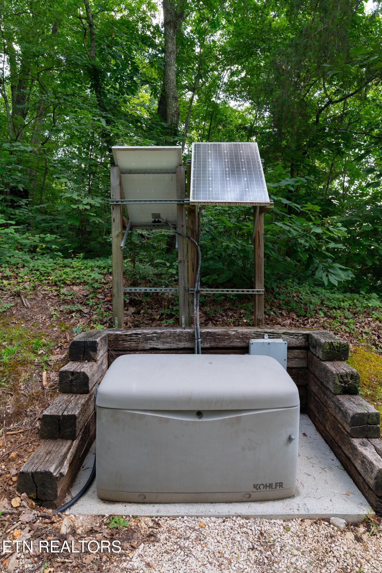 9050 Freeland Road Corryton, TN 37721 - Photo 18 of 34 a view of a patio with couches table and chairs with wooden fence and plants