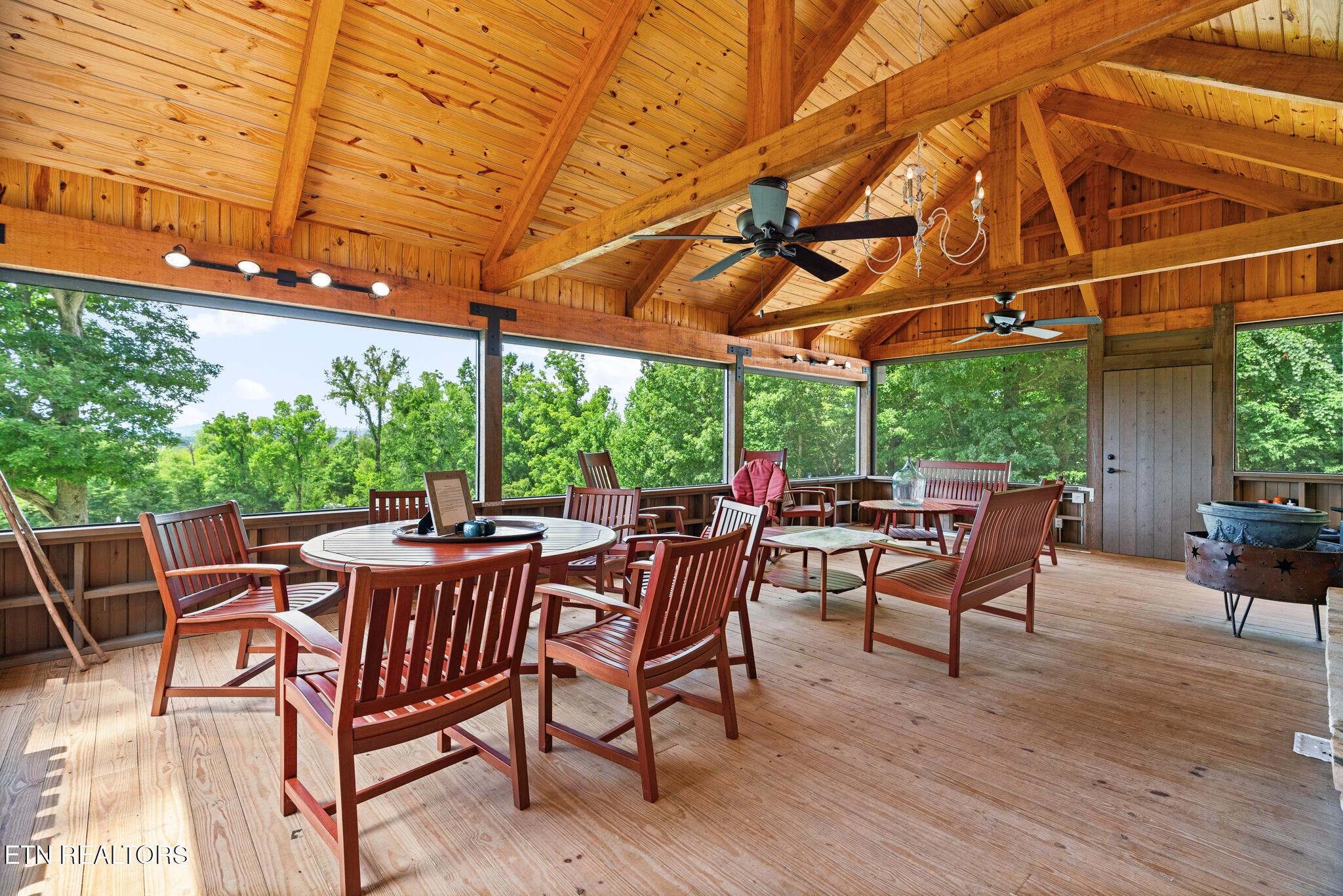 9050 Freeland Road Corryton, TN 37721 - Photo 9 of 34 a view of a patio with table and chairs and wooden floor