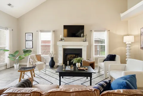 a living room with furniture fireplace and window