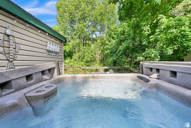 655 Ogden Canyon Road Ogden, UT 84401 - Photo 46 of 50 Outdoor spa with bubbling water, set against a backdrop of mature trees